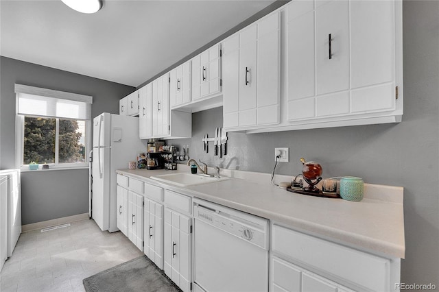 7973 Chase Cir Unit 56, Arvada, CO 80003 - kitchen featuring white appliances, a sink, baseboards, light countertops, and white cabinetry