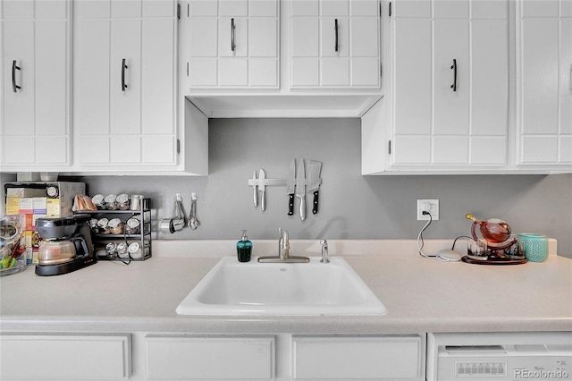 7973 Chase Cir Unit 56, Arvada, CO 80003 - kitchen featuring a sink, light countertops, dishwasher, and white cabinets