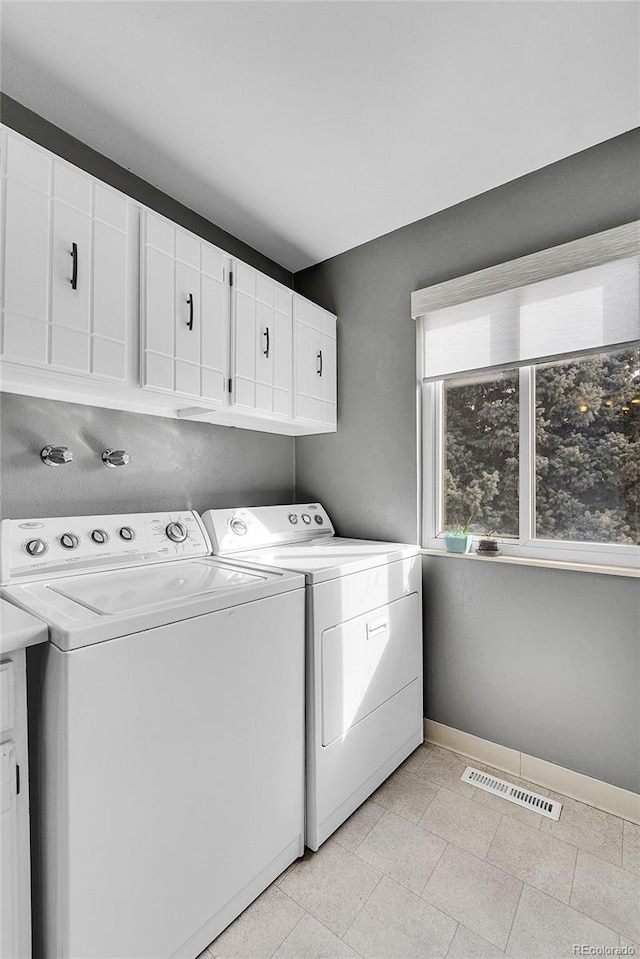 7973 Chase Cir Unit 56, Arvada, CO 80003 - clothes washing area featuring washing machine and dryer, cabinet space, and baseboards