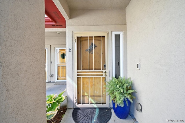920 S Locust St Unit E, Denver, CO 80224 - doorway to property featuring stucco siding