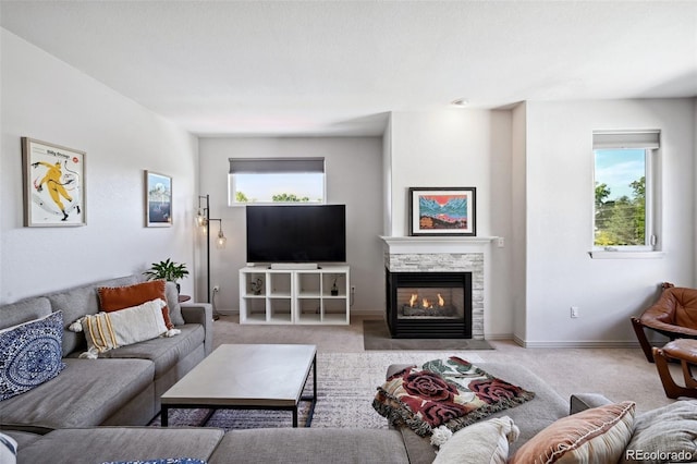 920 S Locust St Unit E, Denver, CO 80224 - living room featuring carpet floors and a stone fireplace