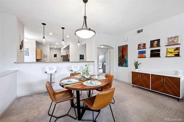 920 S Locust St Unit E, Denver, CO 80224 - dining room with arched walkways, light colored carpet, and recessed lighting