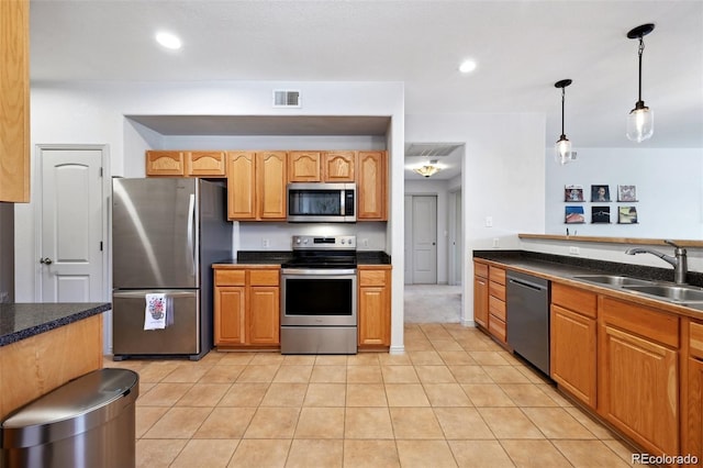 920 S Locust St Unit E, Denver, CO 80224 - kitchen featuring appliances with stainless steel finishes, dark countertops, pendant lighting, light tile patterned floors, and recessed lighting