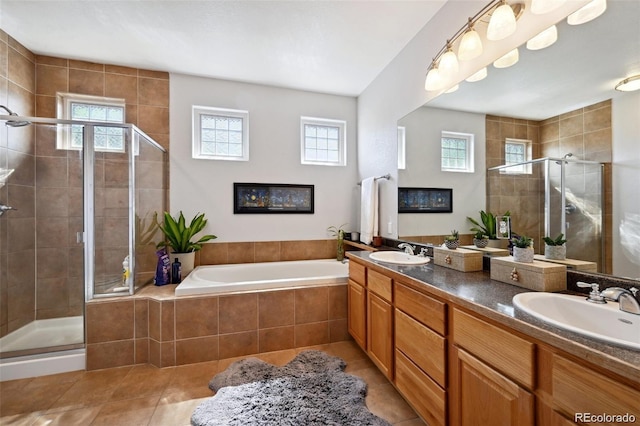 920 S Locust St Unit E, Denver, CO 80224 - full bath with tile patterned floors, healthy amount of natural light, a shower stall, and double vanity