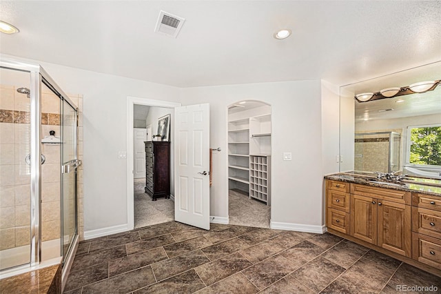 bathroom featuring vanity and walk in shower