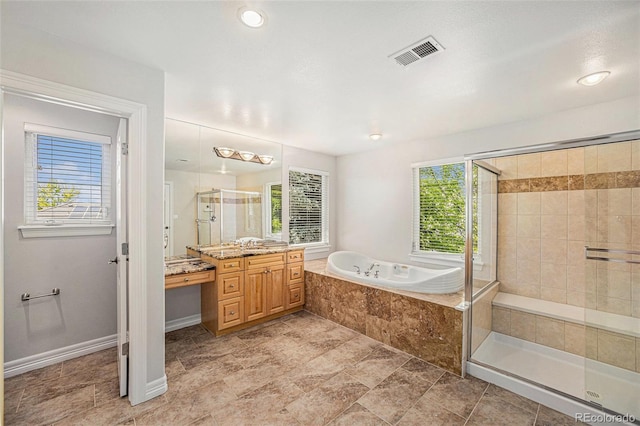 bathroom with vanity and shower with separate bathtub