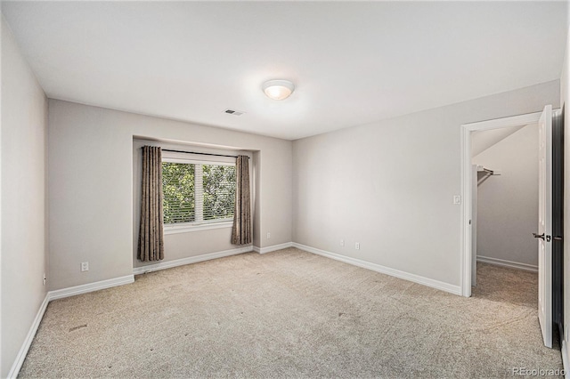 spare room featuring light colored carpet