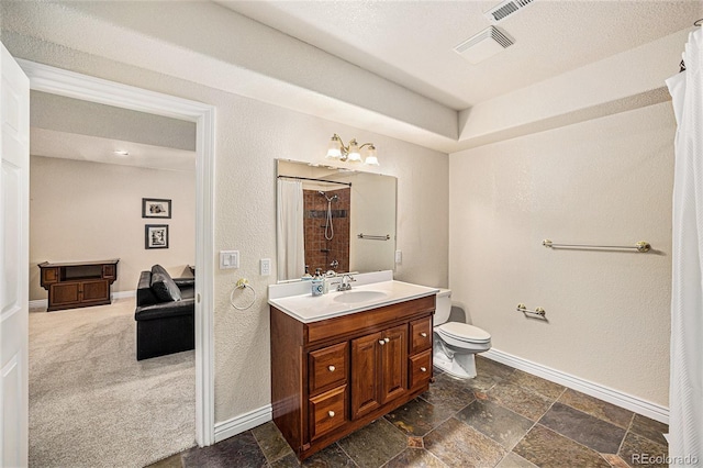 bathroom featuring a notable chandelier, vanity, and toilet