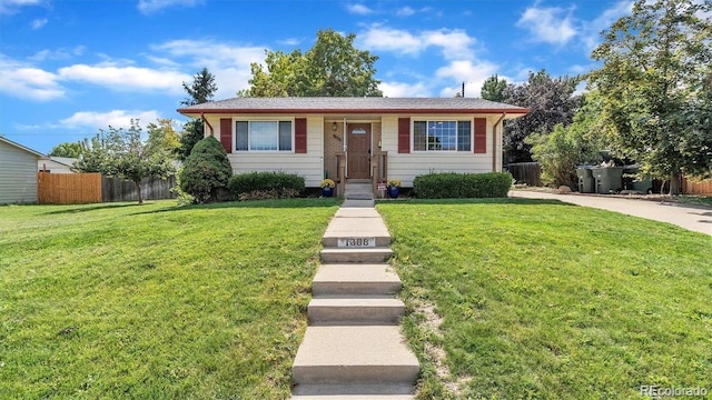 view of front of property with a front yard and fence