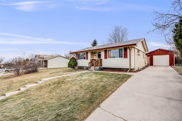 view of front of house featuring an outdoor structure, concrete driveway, a garage, and a front yard