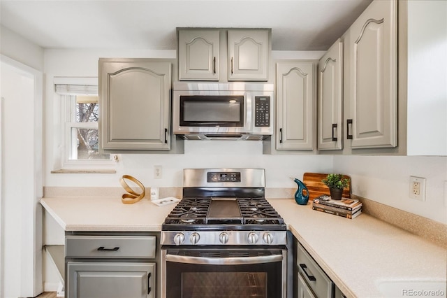 kitchen with light countertops, gray cabinets, and stainless steel appliances