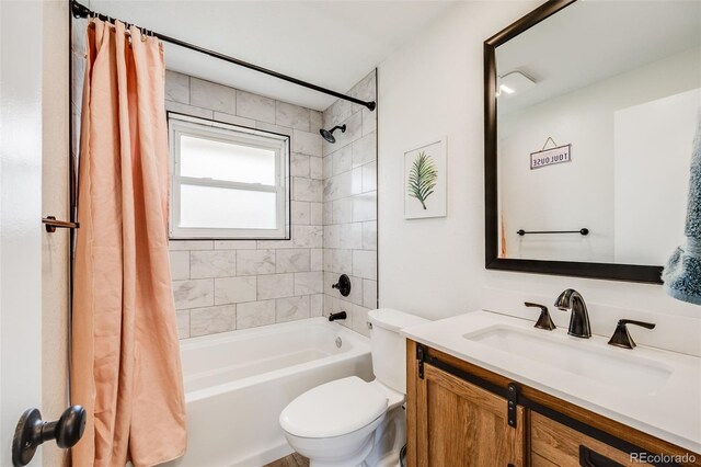 bathroom with shower / tub combo with curtain, vanity, and toilet