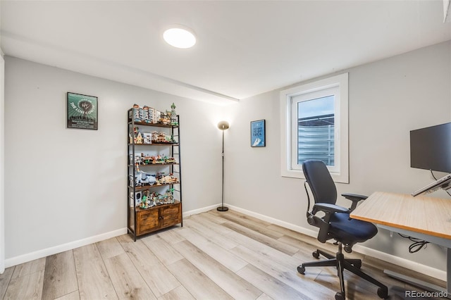 office featuring light wood-type flooring and baseboards