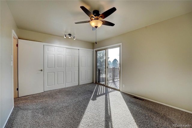 unfurnished bedroom featuring access to exterior, ceiling fan, a closet, and carpet