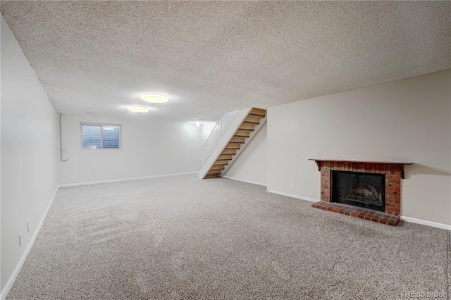 basement with carpet flooring, a fireplace, and a textured ceiling