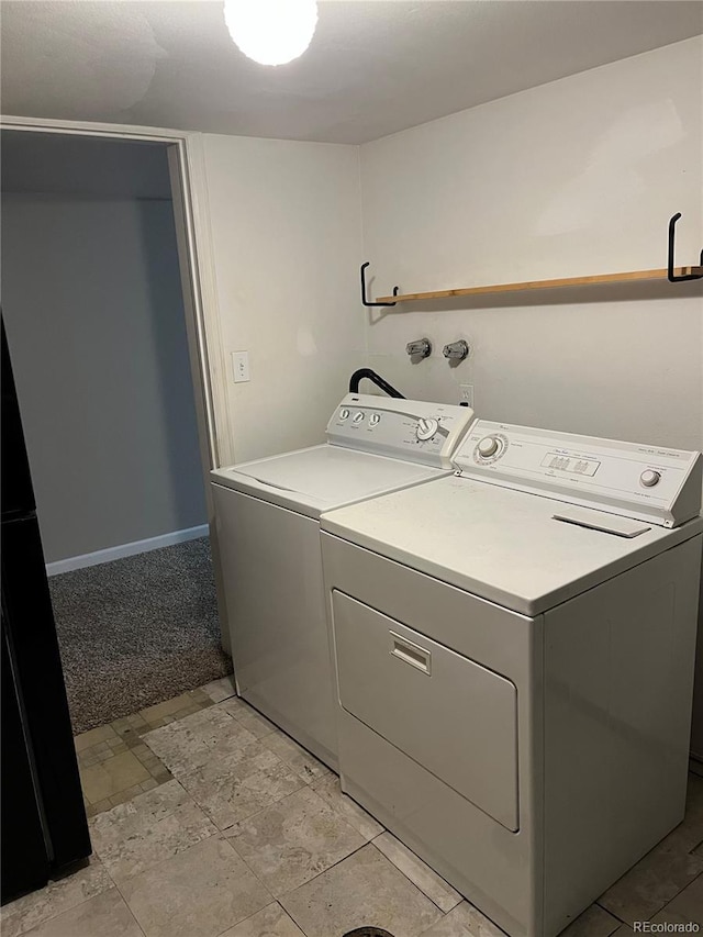 laundry area featuring washing machine and dryer and light colored carpet