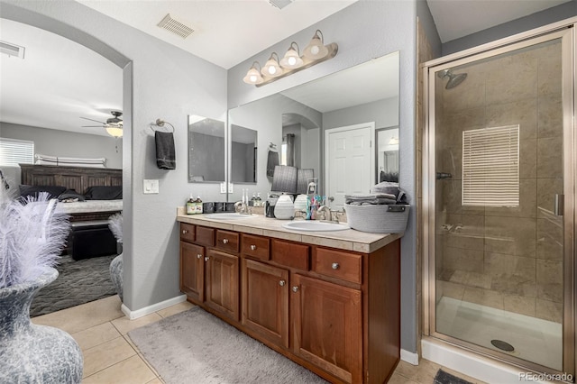 ensuite bathroom featuring ensuite bathroom, a sink, visible vents, and tile patterned floors