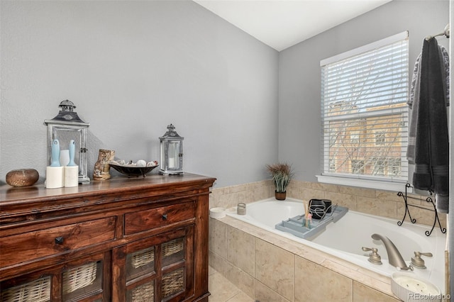 full bath with plenty of natural light and a garden tub