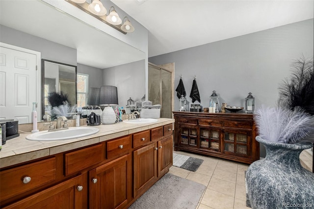 full bath with double vanity, tile patterned flooring, a sink, and a shower stall