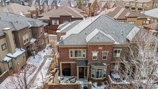 snowy aerial view with a residential view