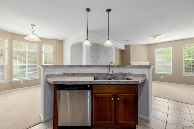 kitchen featuring light carpet, a sink, open floor plan, baseboards, and stainless steel dishwasher