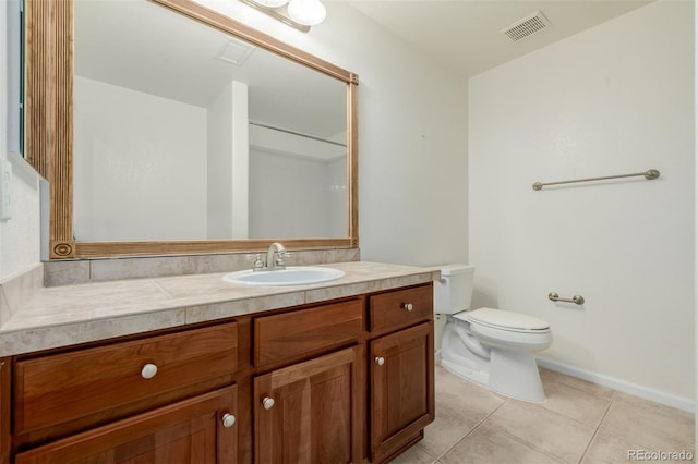 bathroom with visible vents, vanity, toilet, baseboards, and tile patterned floors
