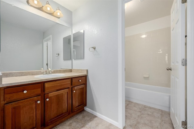 full bath with vanity, baseboards, and tile patterned floors