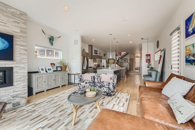 3632 N Pecos St, Denver, CO 80211 - living area featuring light wood finished floors, stairs, recessed lighting, and a fireplace