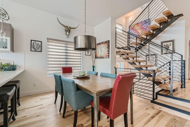 3632 N Pecos St, Denver, CO 80211 - dining space featuring light wood-type flooring, stairs, and baseboards