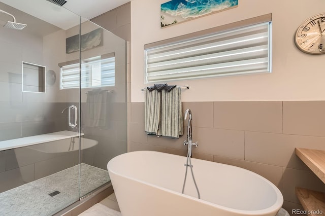 3632 N Pecos St, Denver, CO 80211 - bathroom featuring tile walls, a freestanding tub, and a stall shower