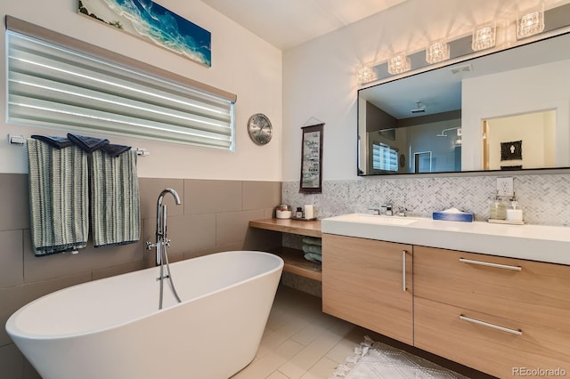 3632 N Pecos St, Denver, CO 80211 - bathroom featuring tile walls, vanity, a freestanding bath, and tile patterned flooring