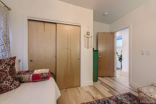 3632 N Pecos St, Denver, CO 80211 - bedroom with light wood-style floors, a closet, and baseboards