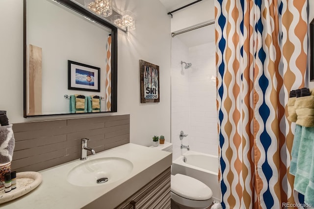3632 N Pecos St, Denver, CO 80211 - bathroom with backsplash, vanity, a chandelier, toilet, and shower / bath combo with shower curtain