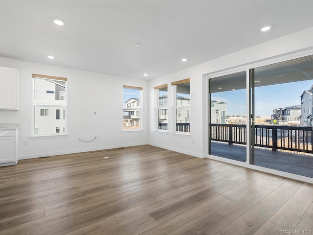 unfurnished room featuring wood finished floors and recessed lighting