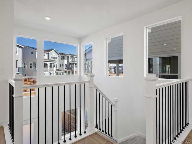 stairs with wood finished floors and baseboards