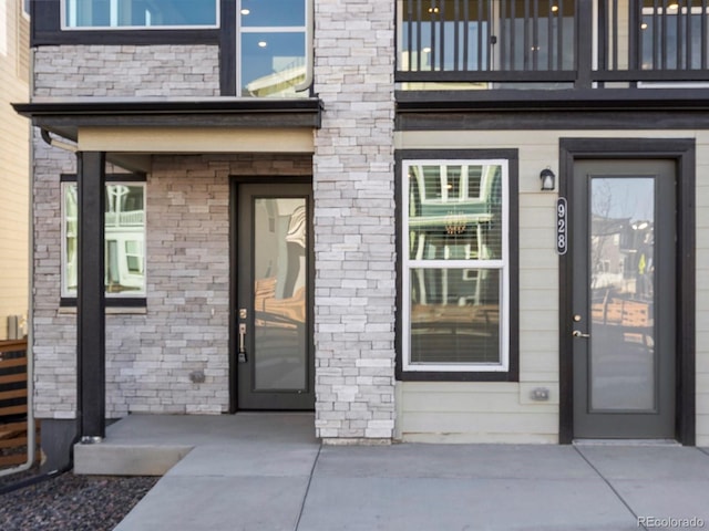 entrance to property with stone siding