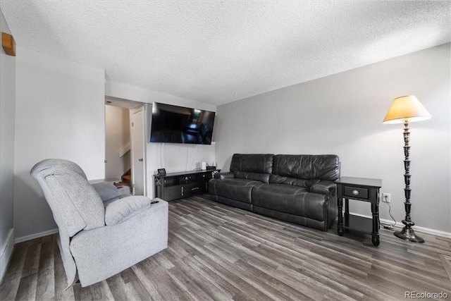 living room featuring hardwood / wood-style floors and a textured ceiling