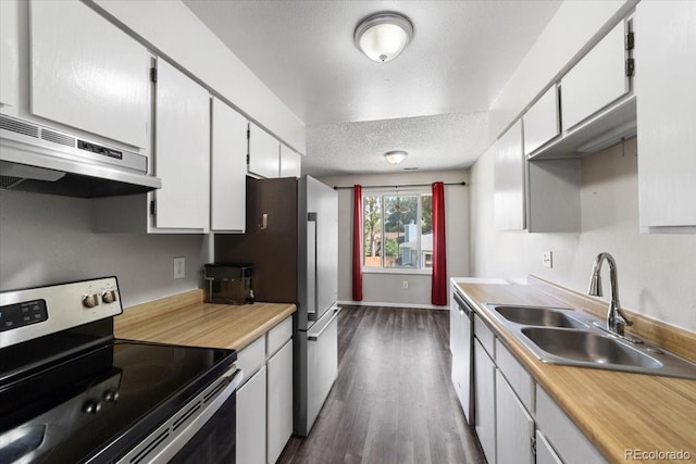 kitchen with dark hardwood / wood-style flooring, white cabinets, sink, a textured ceiling, and appliances with stainless steel finishes