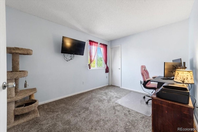 carpeted home office featuring a textured ceiling