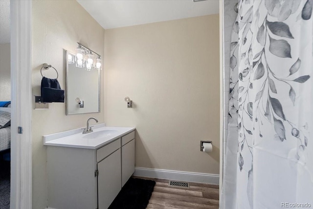 bathroom with hardwood / wood-style flooring and vanity