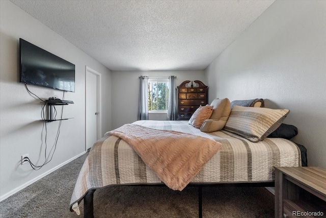 bedroom featuring a textured ceiling and dark colored carpet