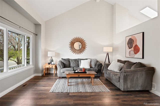 living room with high vaulted ceiling, visible vents, baseboards, and wood finished floors