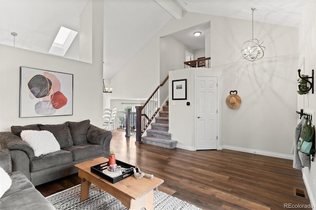 living room with dark wood-style flooring, an inviting chandelier, stairway, beamed ceiling, and a skylight