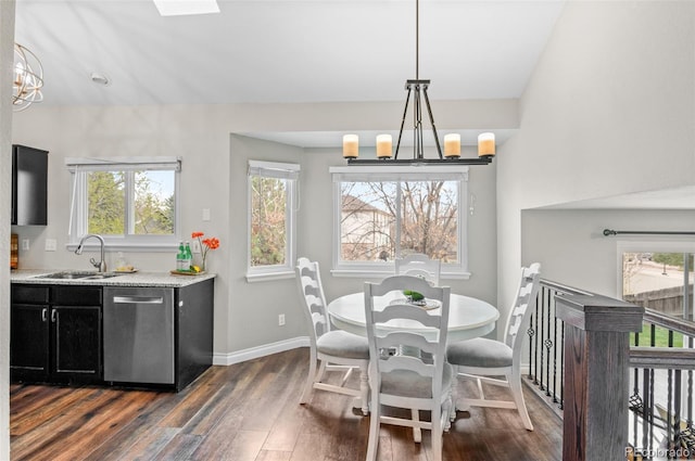 dining room with a notable chandelier, dark wood-style flooring, and baseboards