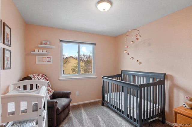carpeted bedroom with baseboards and a crib