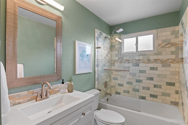 bathroom with a textured wall, vanity, shower / tub combination, and toilet
