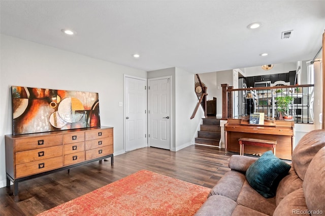 living area featuring baseboards, recessed lighting, wood finished floors, and stairs