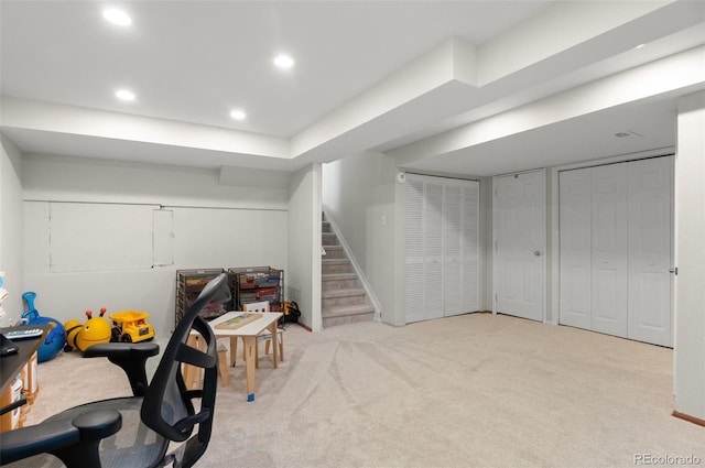 finished below grade area featuring carpet floors, recessed lighting, and stairs