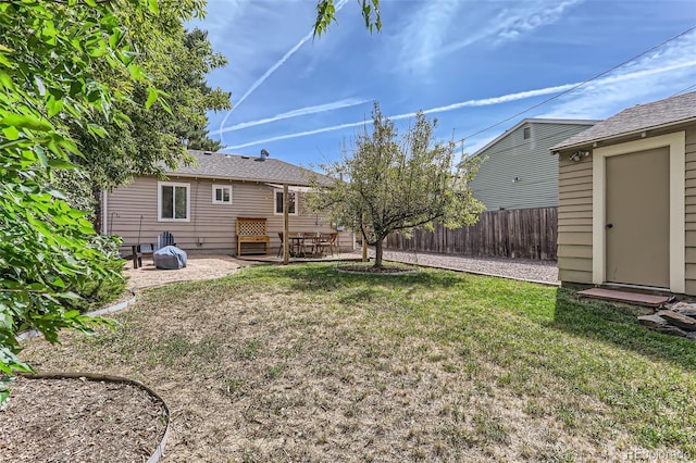 1171 Syracuse St, Denver, CO 80220 - view of yard featuring a patio area, an outbuilding, and a storage unit