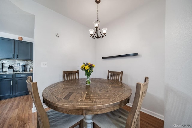 dining area featuring a notable chandelier and hardwood / wood-style flooring